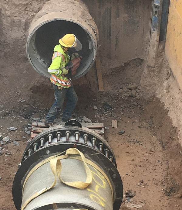 worker-next-to-pipe