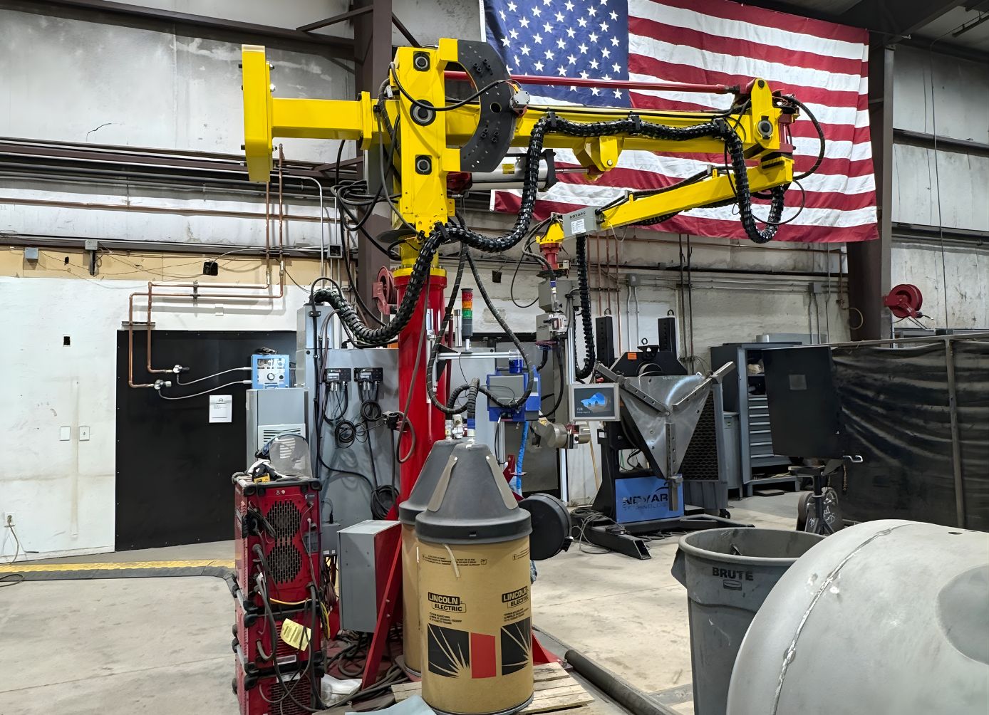 Autonomous Novarc robotic welder performing precision pipe welding in the PPS fabrication shop.